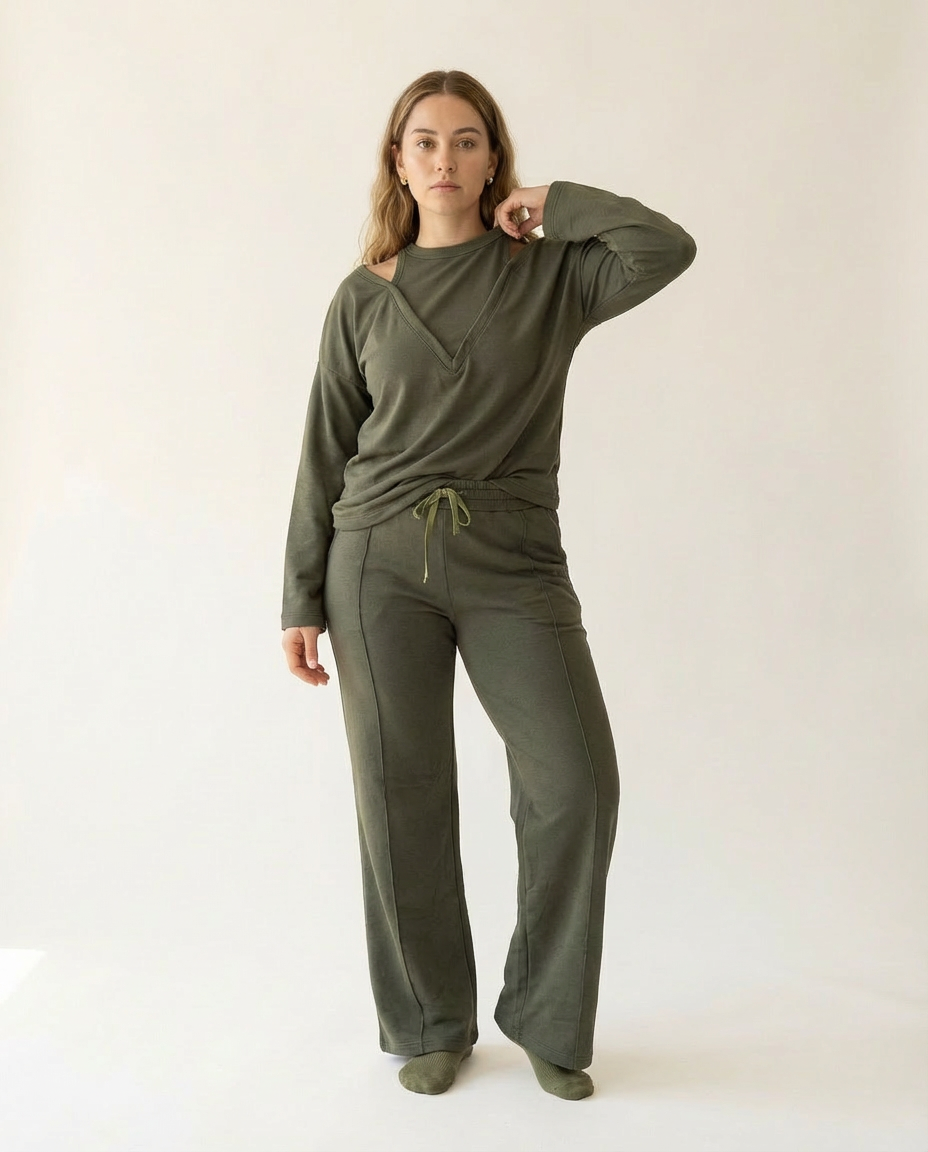 Woman wearing an olive green outfit on a white background