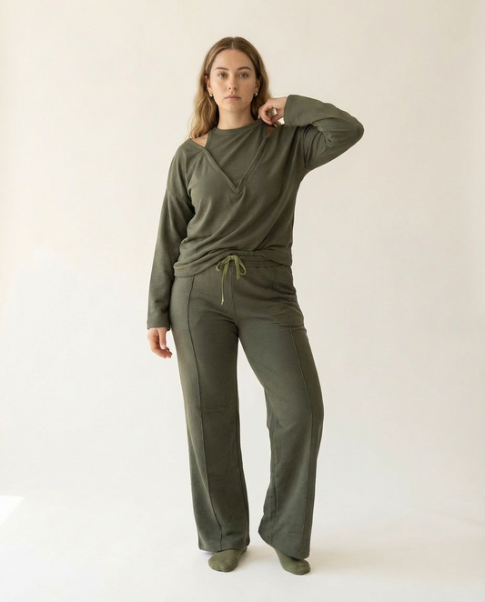 Woman wearing an olive green outfit on a white background