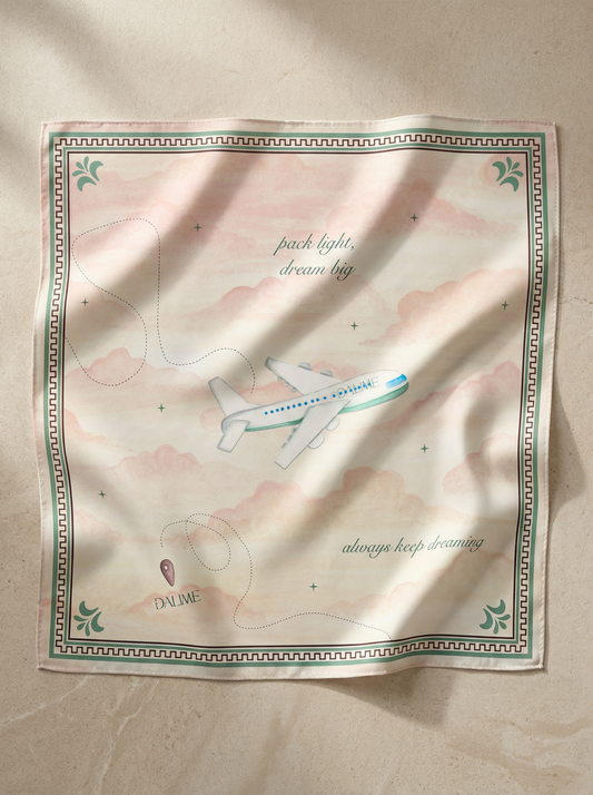 Silk scarf with airplane design and text on a beige background